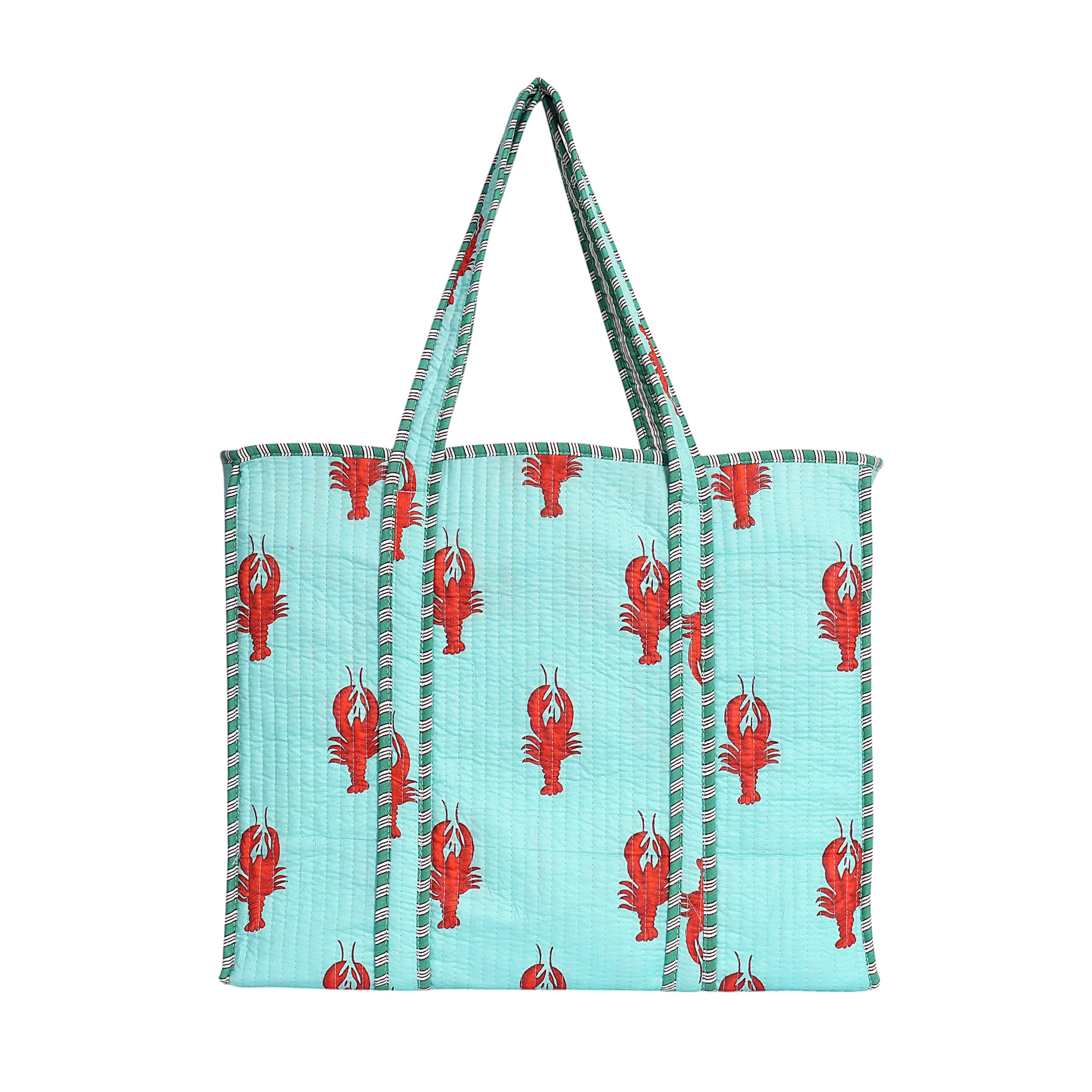 Detail of the hand-block-printed red lobster motif against natural cream cotton