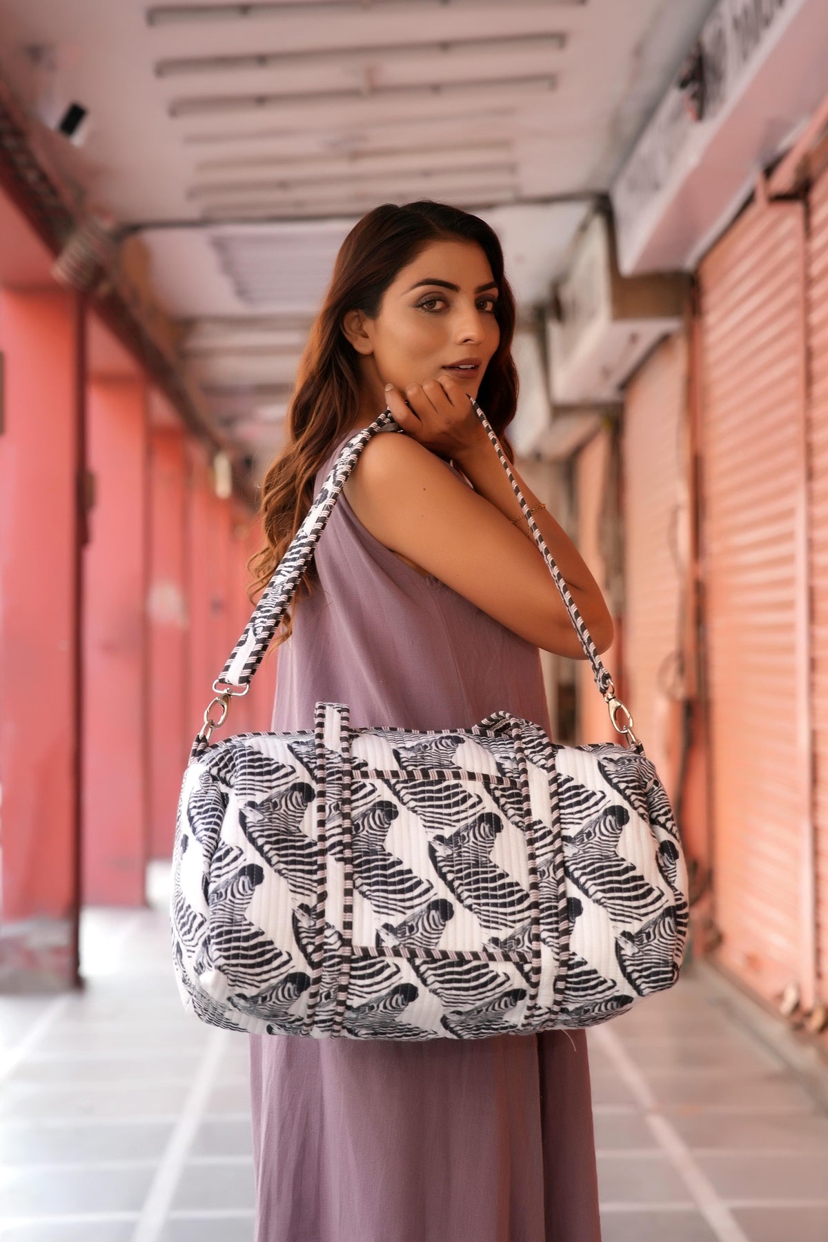The Zebra Weekender close up on the shoulder, showing straight-line quilting: handmade cotton weekender, ethically crafted in Rajasthan.