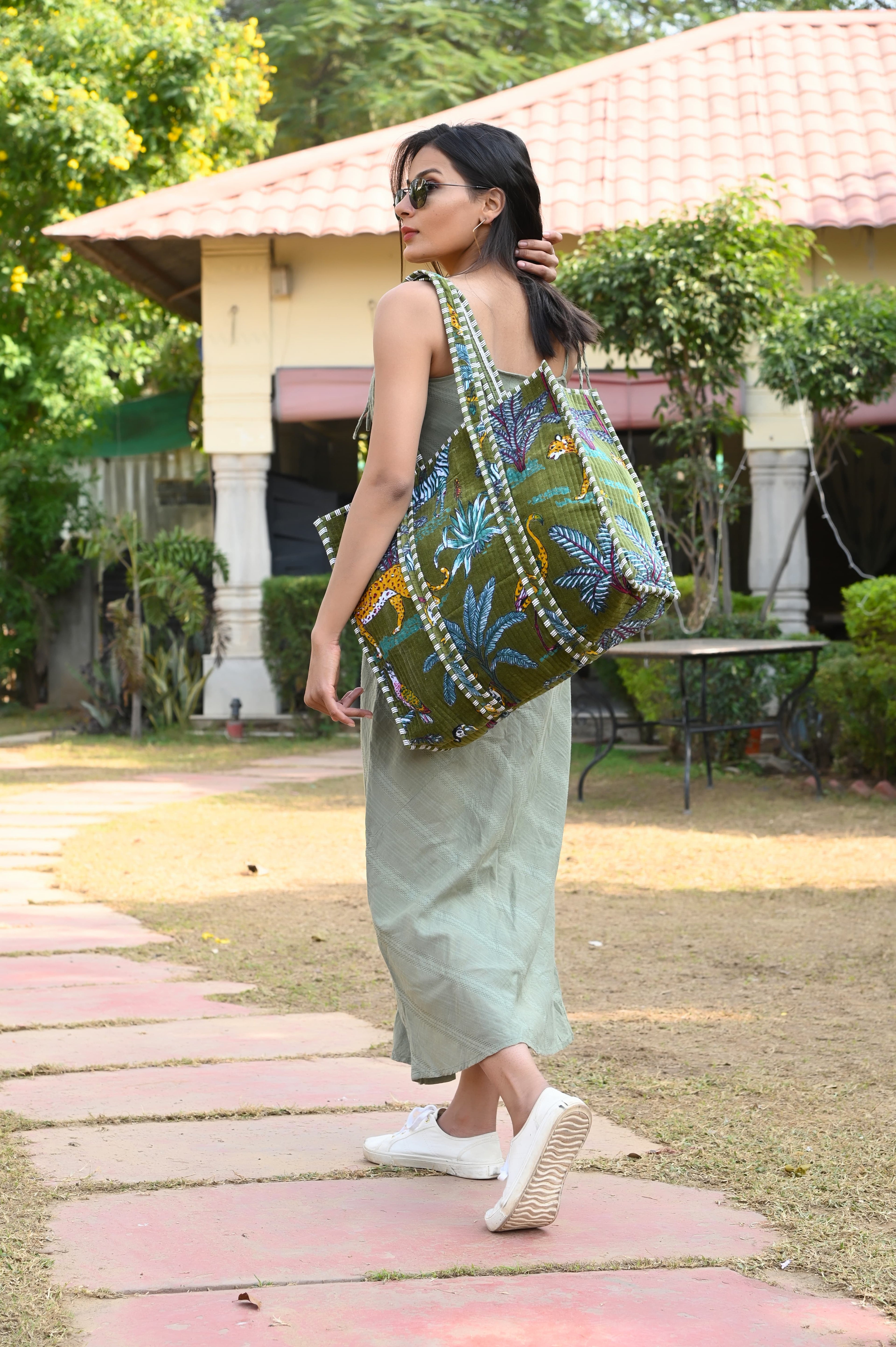 Model carrying The Jungle Tote in Velvet on the shoulder over an autumn coat