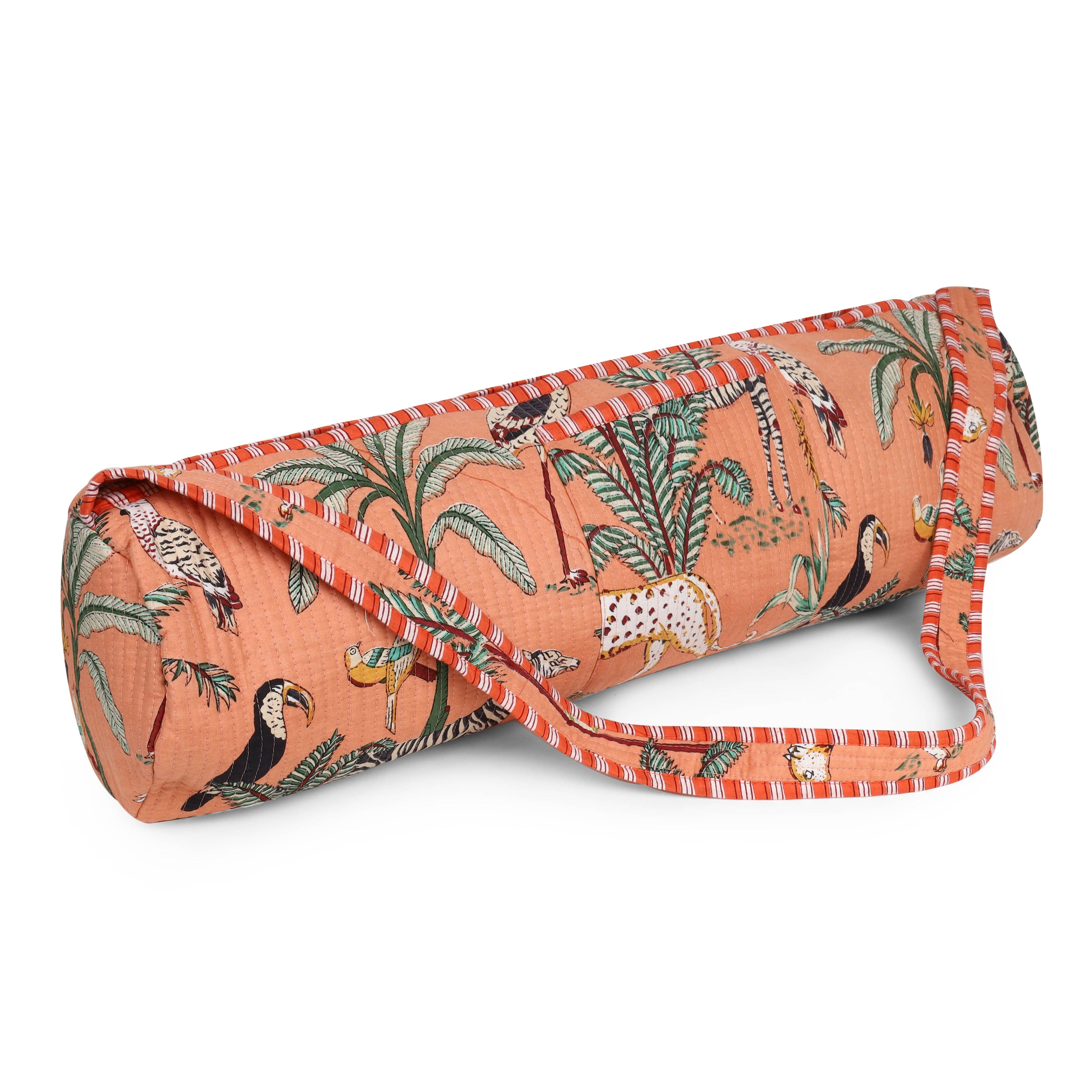 Model carrying The Jungle Yoga Bag over the shoulder with rolled yoga mat inside, walking to a studio