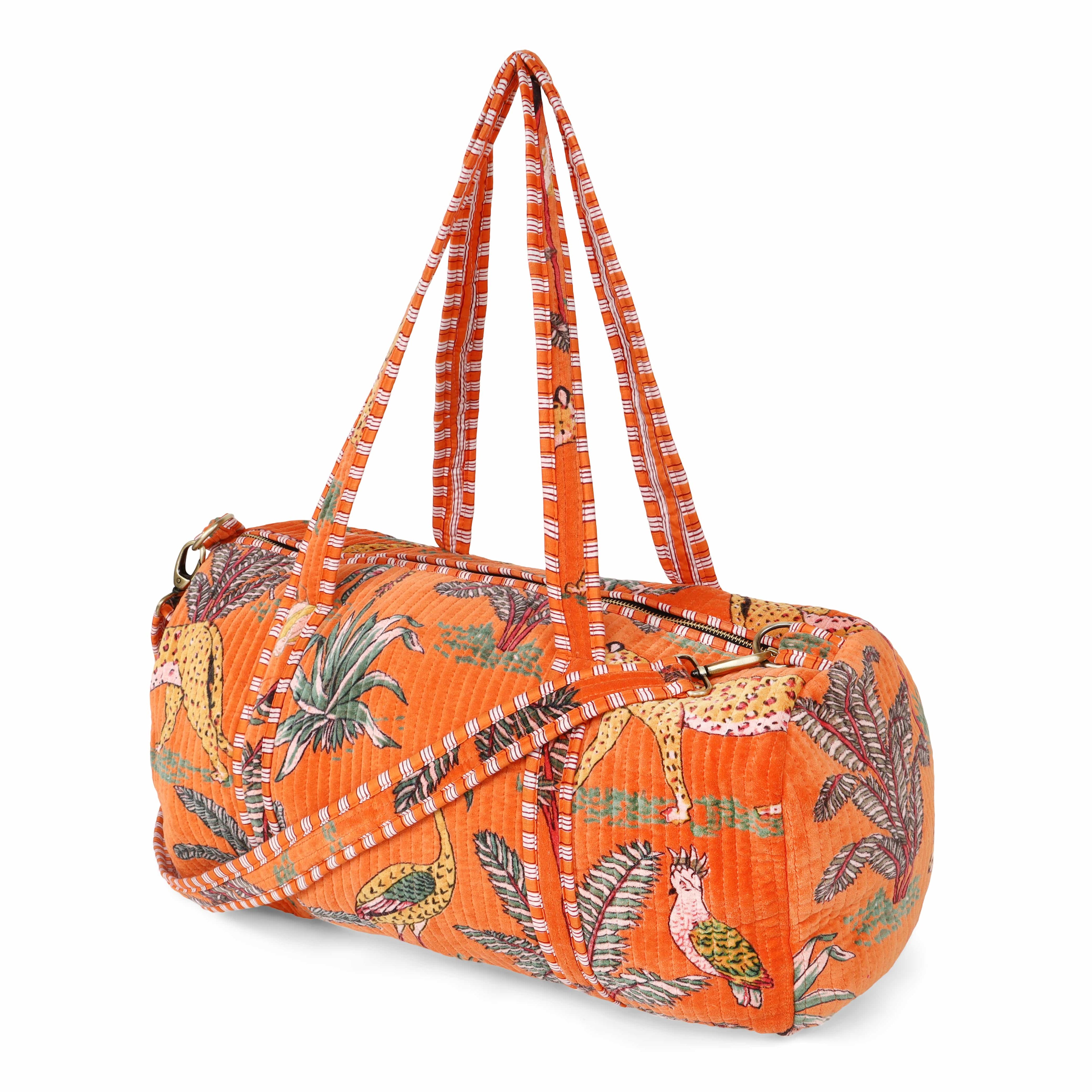 Front view of The Jungle Velvet Weekender in deep saturated colour with the hand-block-printed jungle motif filling the body