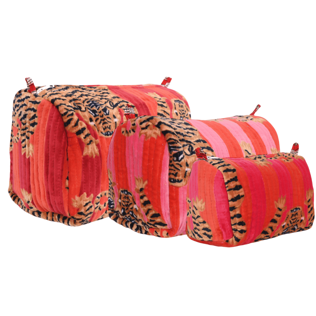 Three Tibetan Tiger Velvet travel pouches in coordinated sizes, stacked together to show the nesting set