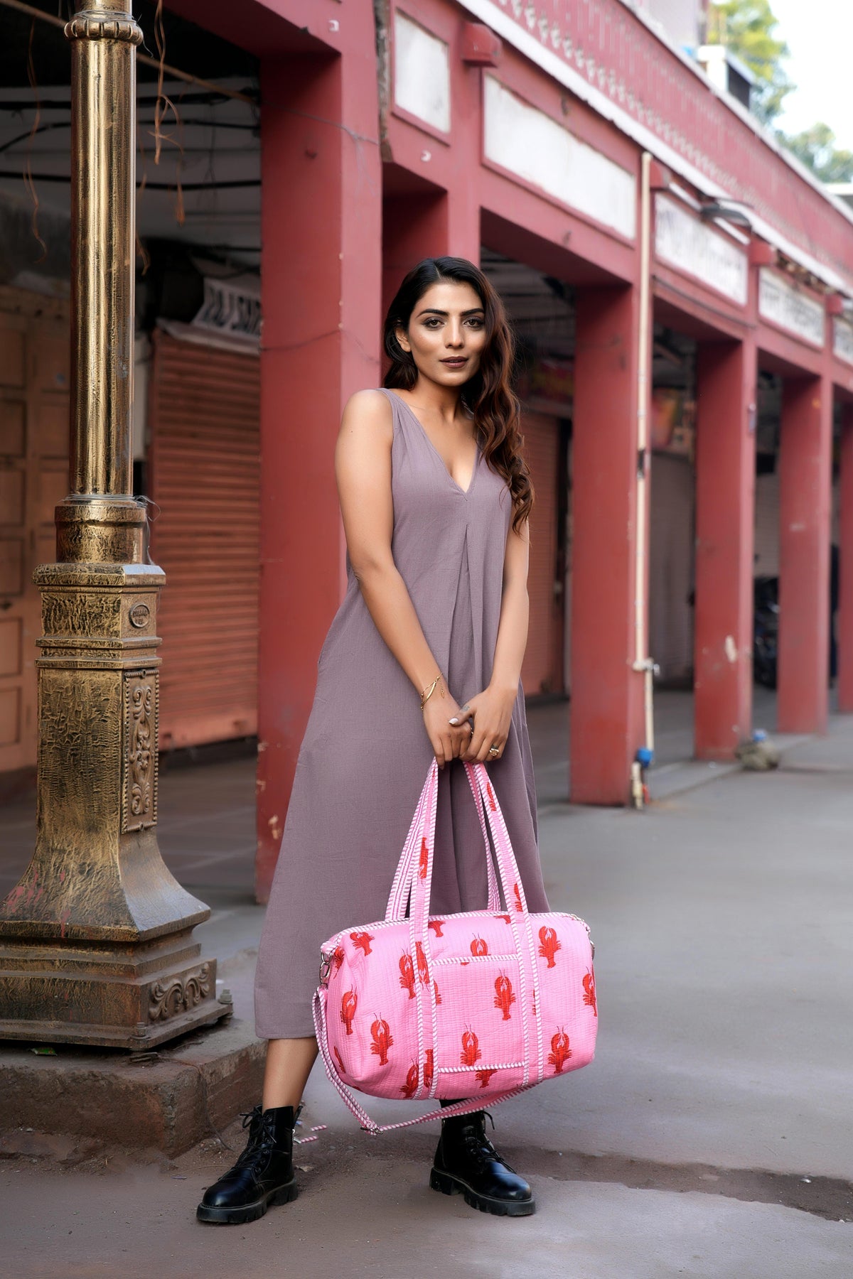 A handmade cotton weekender carried through a Rajasthan street — the bags this care guide is about.