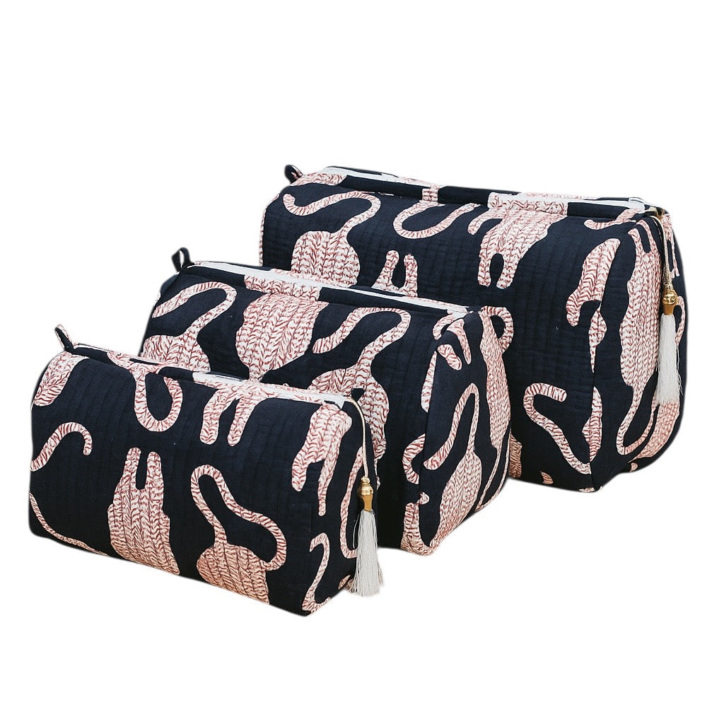 Two black cosmetic bags with pink abstract patterns on a white background