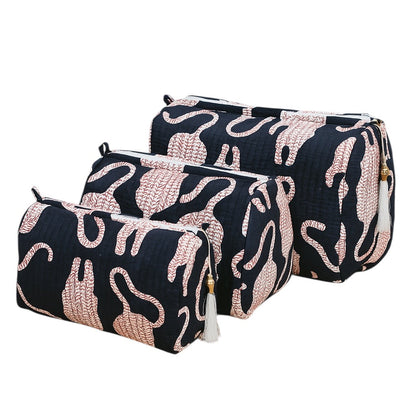 Two black cosmetic bags with pink abstract patterns on a white background