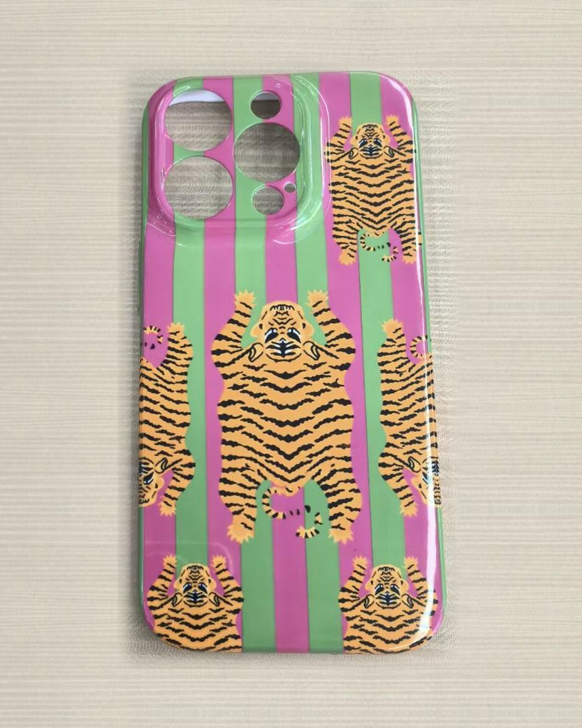 The Tibetan Tiger iPhone Case in Green and Pink — close view of the glossy printed back and camera cutout