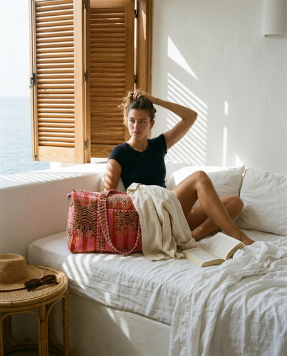 Whitewashed bedroom morning with the Tibetan Tiger Velvet Weekender in Pink — handmade in Rajasthan by Conscious Yoga Collective
