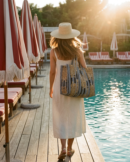 Golden hour beach club deck walk with the Tibetan Tiger Tote in Black and Grey over shoulder — handmade in Rajasthan by Conscious Yoga Collective