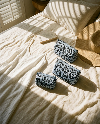 Rumpled hotel bed morning with the Leopard Travel Set in Blue on the linen sheets — handmade in Rajasthan by Conscious Yoga Collective