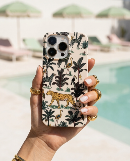 The Jungle iPhone Case in Cream in a modern editorial poolside shot with pistachio parasols and chalk white concrete