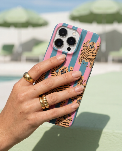 The Tibetan Tiger iPhone Case in Pink and Teal held with hard midday sun raking across the print