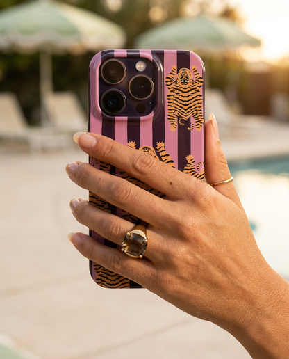 The Tibetan Tiger iPhone Case in Mauve Plum in a sideways pinch grip with a smoky quartz cocktail ring at golden hour