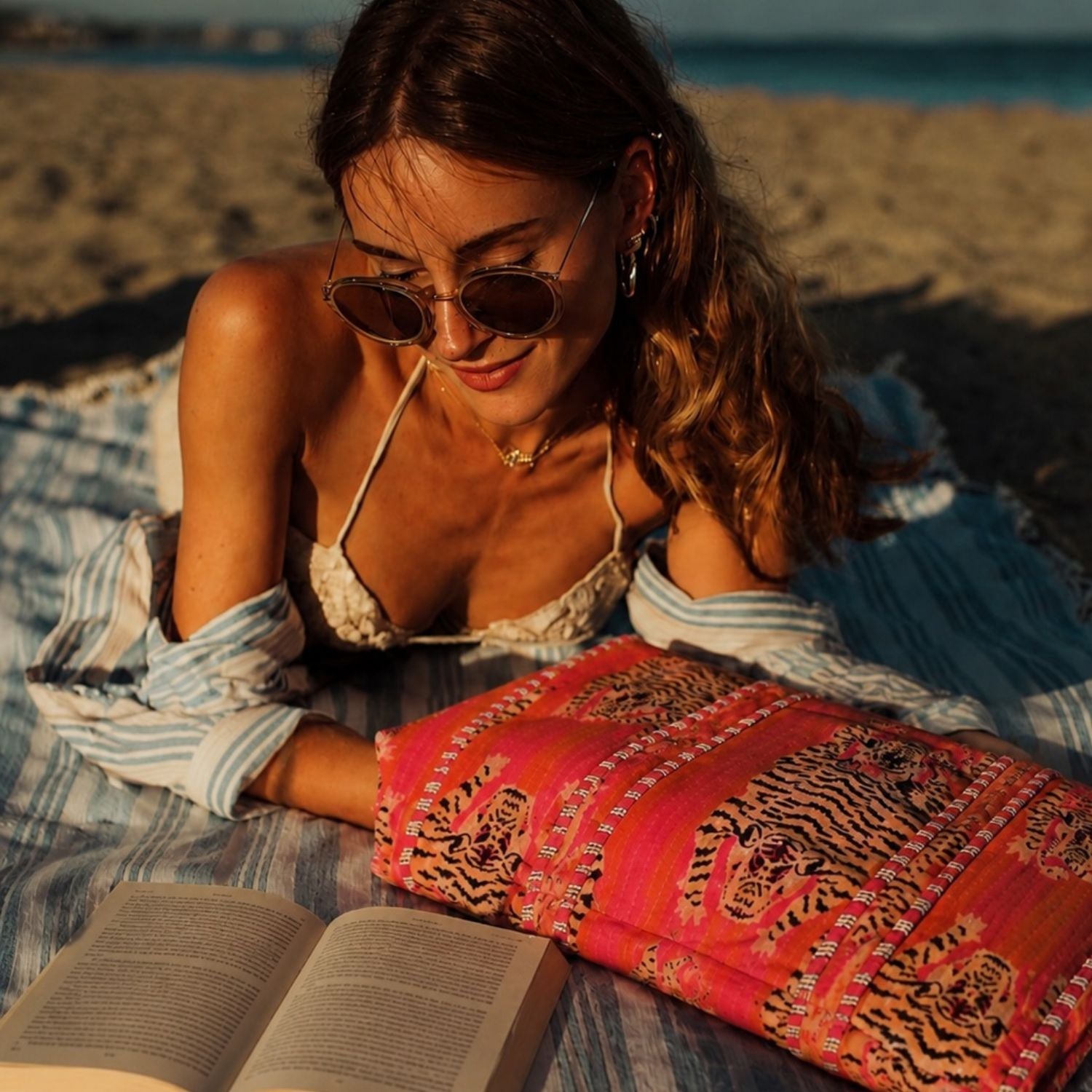 Italian beach moment with the Tibetan Tiger Striped Velvet bag in pink and orange — handmade quilted velvet from Conscious Yoga Collective, hand-block-printed in Rajasthan