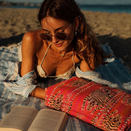 Italian beach moment with the Tibetan Tiger Striped Velvet bag in pink and orange — handmade quilted velvet from Conscious Yoga Collective, hand-block-printed in Rajasthan