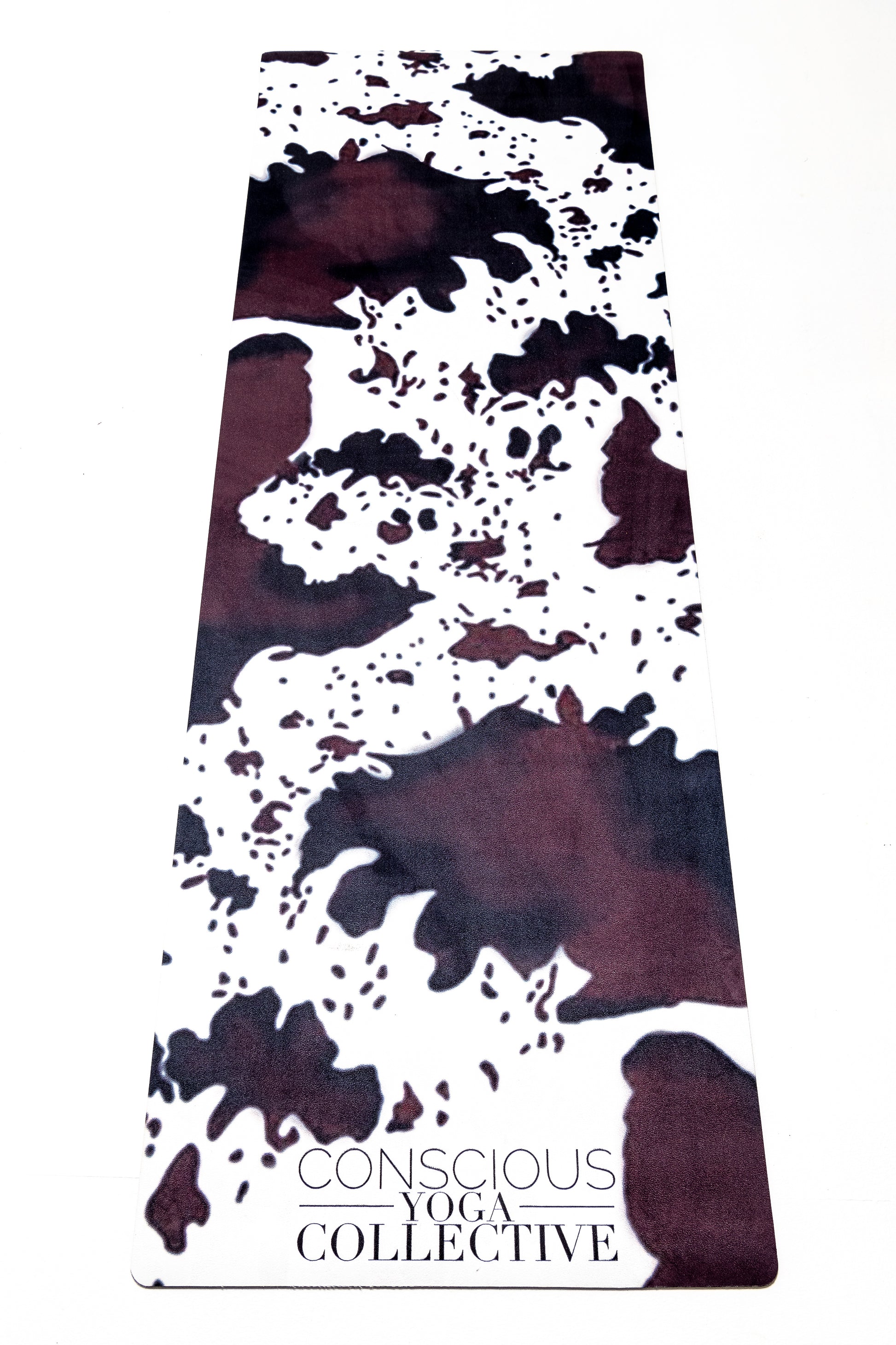 conscious yoga collective yoga mat with cowhide print in brown black and white